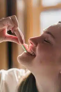 a woman eating with decayed teeth