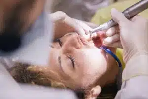 a dentist cleaning a woman's teeth