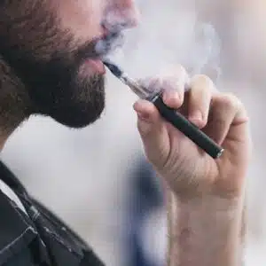 man smoking an electronic cigarette