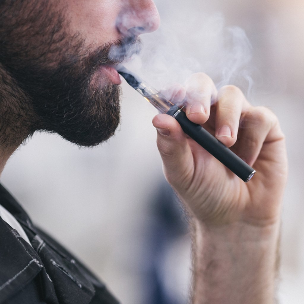 man smoking an electronic cigarette