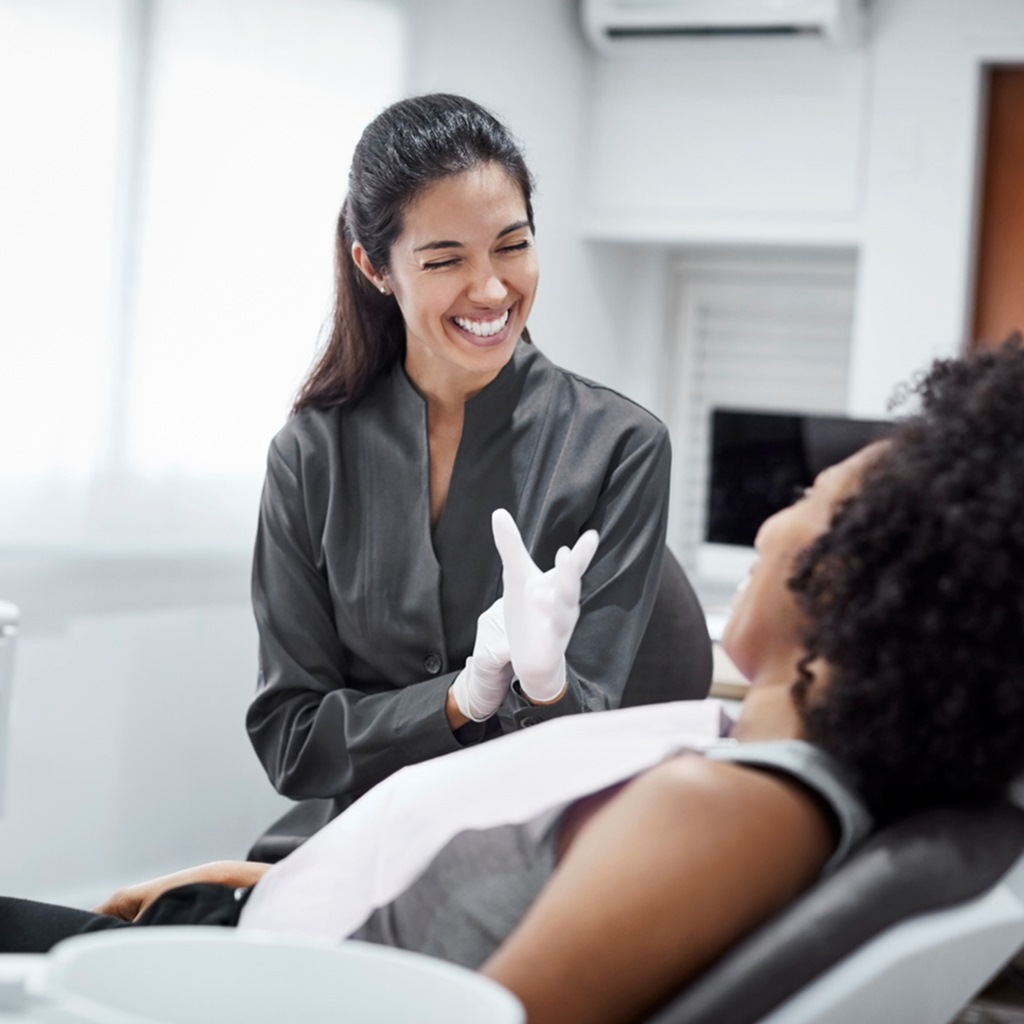 female dentist discussing with patient.