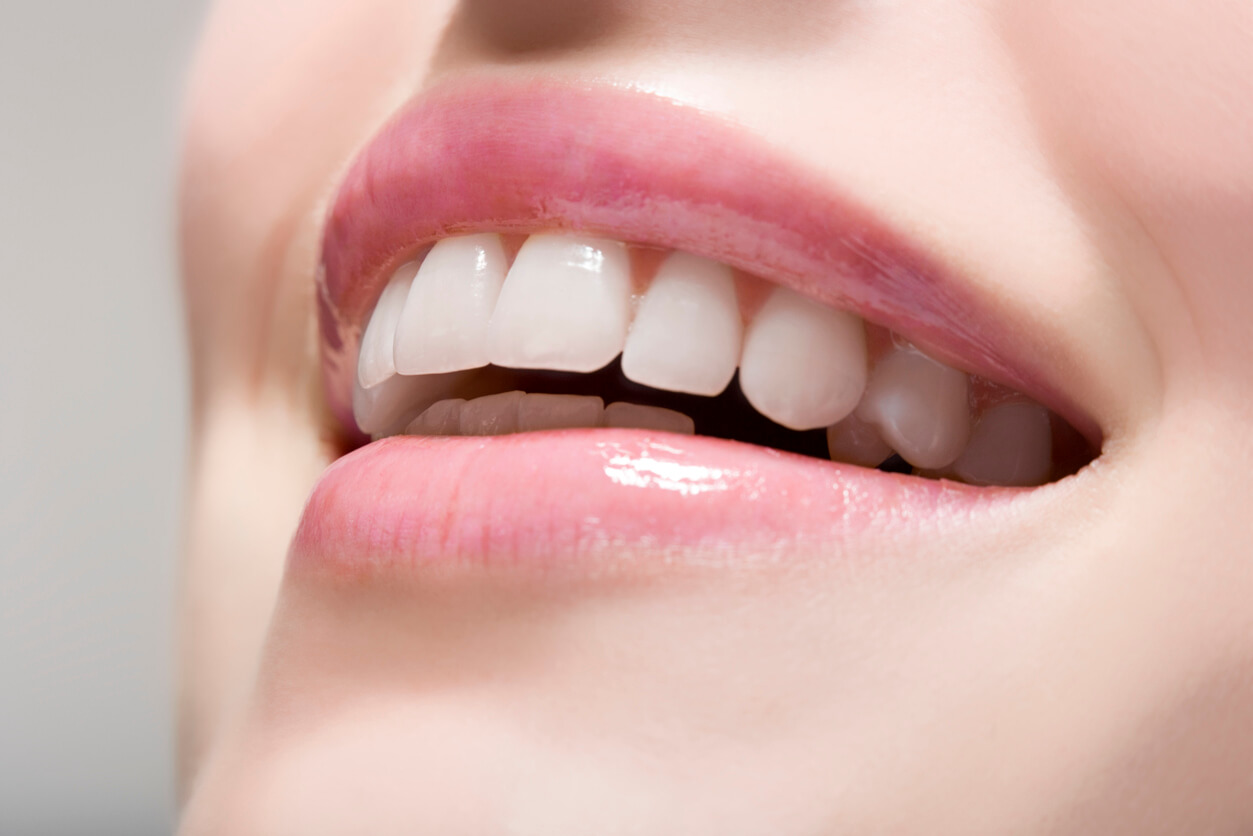 a woman smiling with white teeth