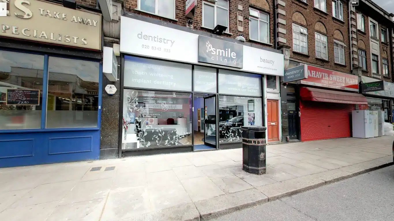 smile cliniq storefront displays dentistry and beauty services on a city street.